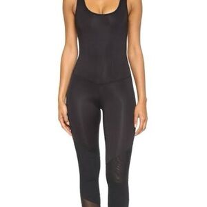 Koral Vector Jumpsuit in Black with mesh panels Size M